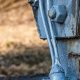 Earth conductors clamped to the foot of a lattice transmission tower leg and running into the concrete foundation